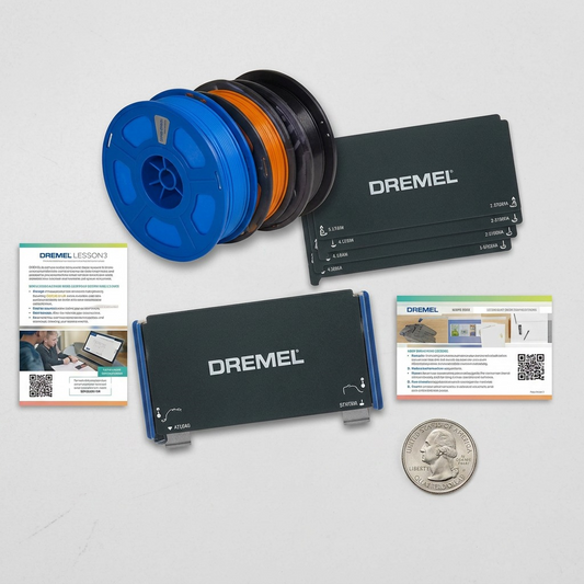 A photorealistic scale reference image showing the the 3DFLEXEDU-KIT on a grey workspace, arranged beside a standard American quarter.
