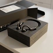 A premium unboxing view of the OPN Sound Osso bone conduction headphones, securely nestled in custom protective foam.