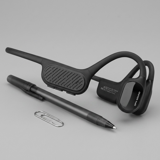 OPN Sound Swym+ headset beside a metal paper clip for size reference.