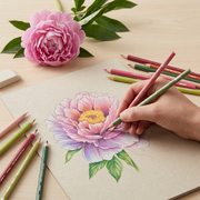 Prismacolor Premier Botanical Garden colored pencils in use on a wooden desk with a hand-drawn illustration and fresh flower.