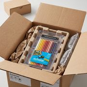 A premium unboxing presentation showing Prismacolor colored pencils (24 count) safely cushioned in protective custom-molded recycled-pulp tray and surrounded by recycled kraft dunnage within an open shipping box.