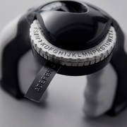 Macro close-up of the embossing wheel and tactile output on the Dymo Organizer Xpress Pro label maker.