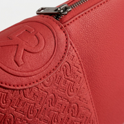 Macro close-up of intricate matching R logo embossing on Bugatti sling bag.