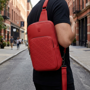 Rick Ross - The Boss Edition Sling Bag worn by a person walking down a city street.