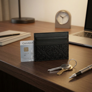 A scale reference image for the Bugatti card holder on a desk with a credit card and keys.