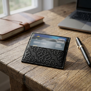 Bugatti Rick Ross - The Boss Edition Card Holder placed on a wooden desk.
