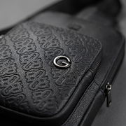 Extreme macro detail showing the intricate repeating debossed RR-G monogram texture on pebbled PU leather.