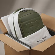 Photograph of the Bugatti grit green backpack being safely unboxed, nestled in protective packaging.