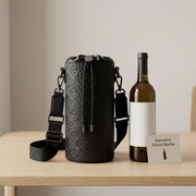 Scale reference photo: Bugatti Rick Ross Champagne Bag (Phantom Black) of image_0.png shown beside a standard 750ml glass wine bottle to illustrate its size.