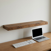 Scale reference photo for Entrepot La Grange inc Solid Wood Shelf: length visualized against a standard office keyboard and a 13-inch laptop, emphasizing 48-inch length.