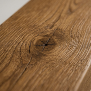 Extreme macro view of the rich whiskey brown wood grain texture of the floating beam mantel.