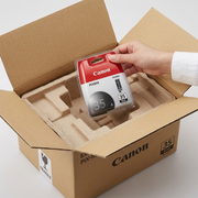 Safe unboxing: a hand lifts the protected Canon PGI-35 ink pack from a sturdy, padded box.