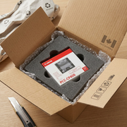 A close-up photograph of the Canon PCC-CP400 paper cassette, as seen in image_0.png, safely nestled in custom foam packaging inside a robust, unbranded shipping box.