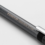 Macro inspection showing the detailed STAEDTLER imprint and ribbed texture on the mechanical pencil.