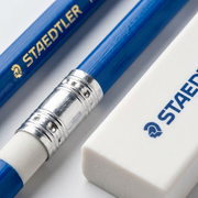 Macro photo of a blue Staedtler pencil with crisp gold logo and a white Staedtler block eraser.